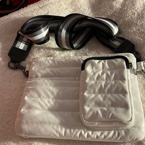 White patent Think Rolyn crossbody bag.